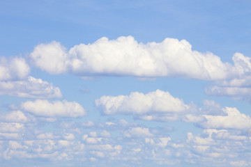 Naklejka na ściany i meble Background of Blue Sky with White Cumulus Clouds.
