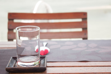 Glass and spoon on table for dinner