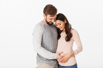 Cheerful young man standing with his pregnant woman