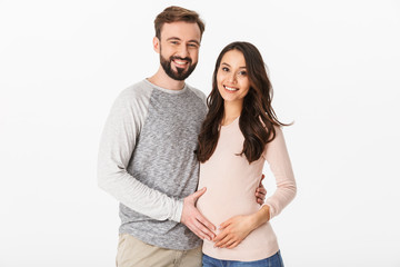 Happy young man standing with his pregnant woman