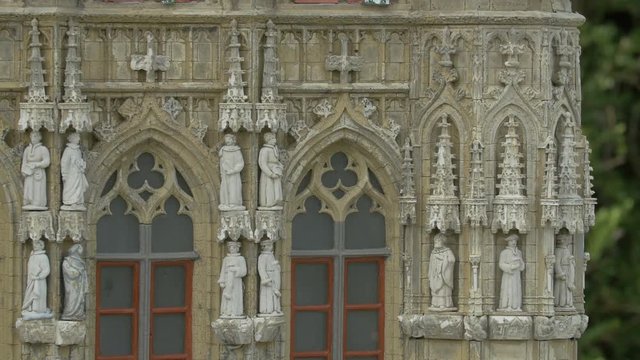 Statues on a miniature building facade
