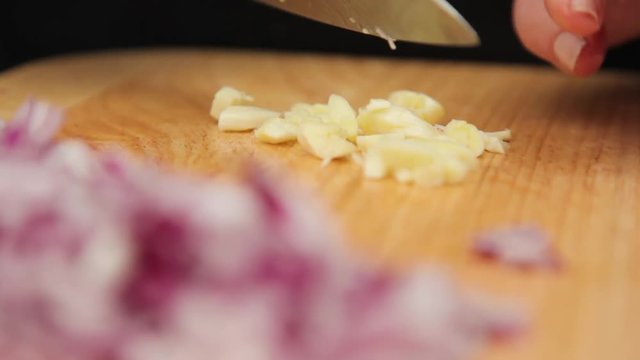 A close up shot of a garlic being chopped.