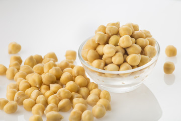 Chickpea grains (Cicer arietinum) in bowl isolated on white background