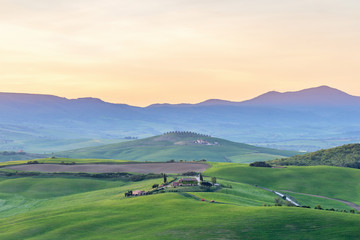 Fototapeta na wymiar Scenic Tuscany landscape view with a farm in a field