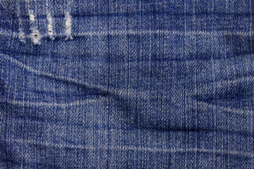 Naklejka premium Jeans texture background. Part of the blue jeans