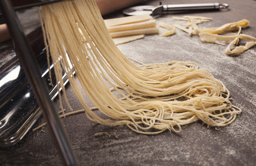 Preparing homemade fettuccine on pasta machine