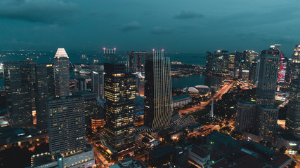 Aerial view of Singapore skyscrapers with city skyline during cloudy evening