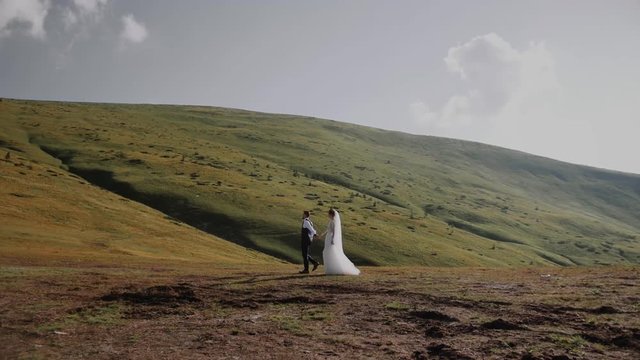 Wedding Couple Walks in Mountains 