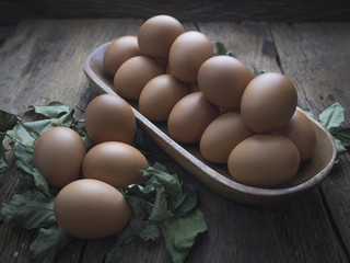Fresh eggs in on old wooden background