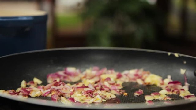 A close up shot of onions and garlic after sauteeing