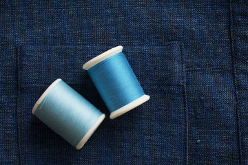 blue tone sewing threads on blue cloth background