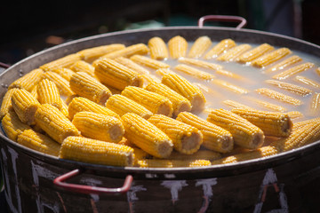 Hot heads of cabbage of boiled corn food outdoors.