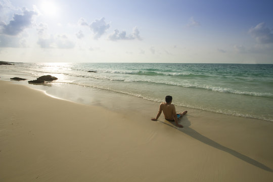 Man relaxing on summer beach alone on his vacation