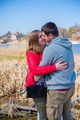 American young couple with overweight walk in park, man and woman together  