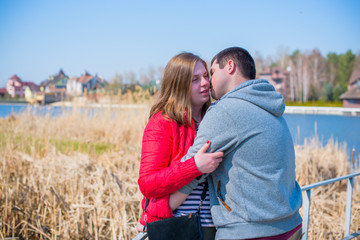 American young couple with overweight walk in park, man and woman together  