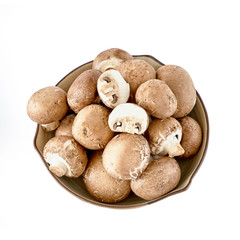 Champignon mushrooms in bowl. Top view. Isolated over white background
