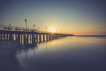 Fototapeta premium Amazing colorful sunrise over the pier in Gdynia Orlowo. Sunrise over the sea.