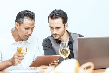 Two business man discuss about work and looking into tablet in meeting day