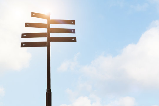 signpost guide direction sign on a pole with blue sky backgrounds