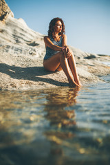 Pretty young woman sitting on the beach