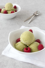 Matcha Ice Cream and Raspberries in two Bowls