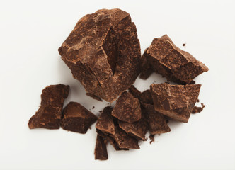 Heap of chocolate pieces isolated on white