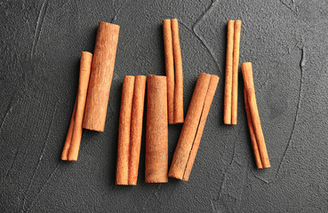 Aromatic cinnamon sticks on dark grey background