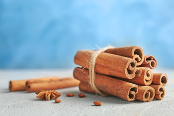 Tied cinnamon sticks on table, closeup
