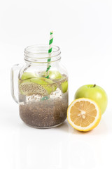 Apple green sliced with chia seeds in glass and fresh apples with lemon on the wooden table, Drink to good health