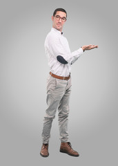 Concept of a young man showing something with his hands - Full body shot