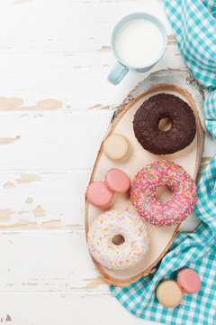 Milk and donuts on wooden table