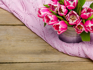 Pink tulip bouquet on retro wooden background, copy space