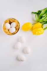 background with white eggs and spring flowers.