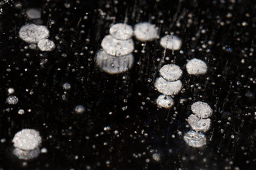 Bubbles formation in ice with black background