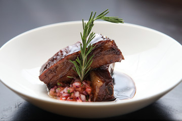 Grilled pork ribs with cane molasses, rosemary and salad