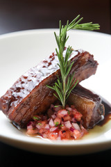 Grilled pork ribs with cane molasses, rosemary and salad