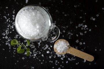 One little wooden spoon filled with sea salt