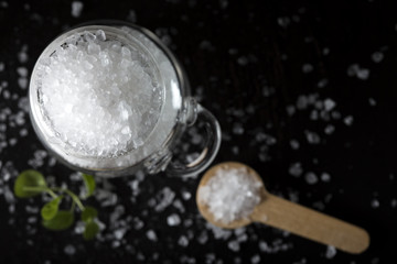 Close up of one glass jar filled with sea salt