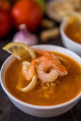 Lentil soup with seafood. Red soup with shrimps and squid, copy space