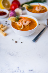 Lentil soup with seafood. Red soup with shrimps and squid