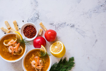 Lentil soup with seafood. Red soup with shrimps and squid