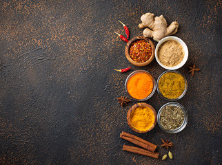 Obraz na płótnie Canvas Traditional Indian spices on rusty background