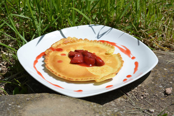Pfannkuchen mit Erdbeeren auf weißem Teller