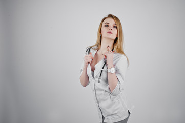 Blonde sexy doctor nurse with stethoscope isolated on white background.