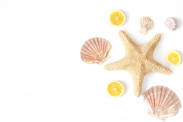 Composition of exotic seashells, oyster, starfish and lemon slices on white wooden background. Tropical summer vacation or sea food concept. Flat lay, top view. Marine design.