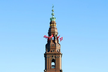 Fototapeta na wymiar Danish flags on the tower. Christiansborg castle, Copenhagen, Denmark.