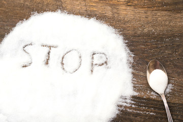 Stop sign made of granular sugar. The picture illustrates the harm of eating sugar and salt, as well as dependence on flavoring additives.