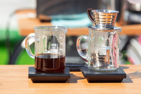 Making pour over coffee at the street market. Rge glass cups with dripper and filter