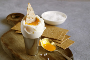 Breakfast. eggs soft-boiled on a gray background.