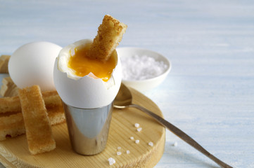Breakfast. eggs soft-boiled on a gray background.